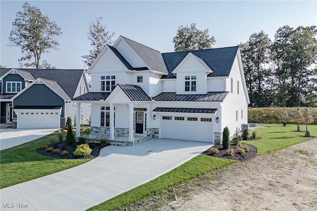 modern farmhouse style home featuring a garage, covered porch, and a front yard