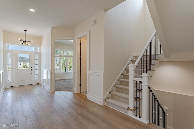 foyer featuring an inviting chandelier and light hardwood / wood-style flooring