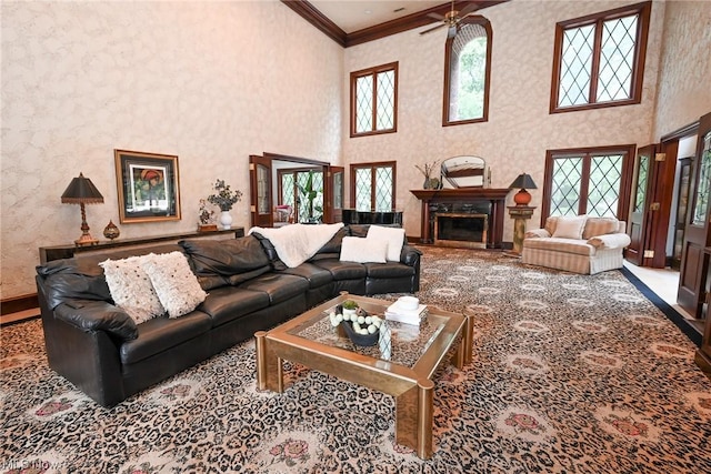 living room with ceiling fan, a healthy amount of sunlight, and ornamental molding