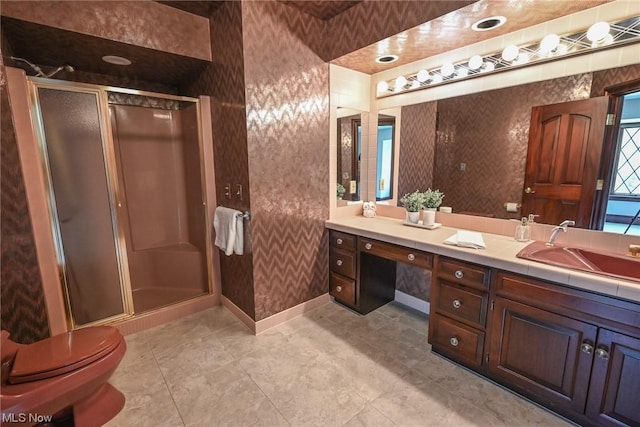 bathroom with a shower with door, vanity, and toilet