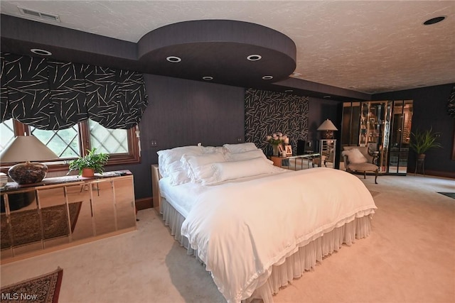 bedroom featuring carpet floors and a textured ceiling