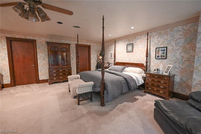 carpeted bedroom featuring ceiling fan and crown molding