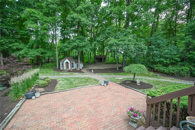 view of patio with an outbuilding