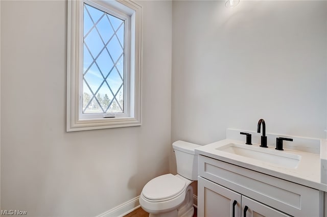 bathroom featuring toilet and vanity