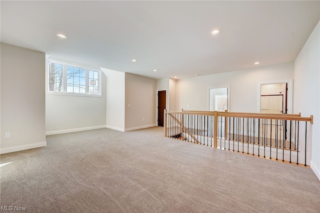 unfurnished room with light carpet