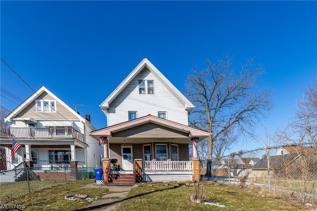 view of front of home with covered porch and a front lawn