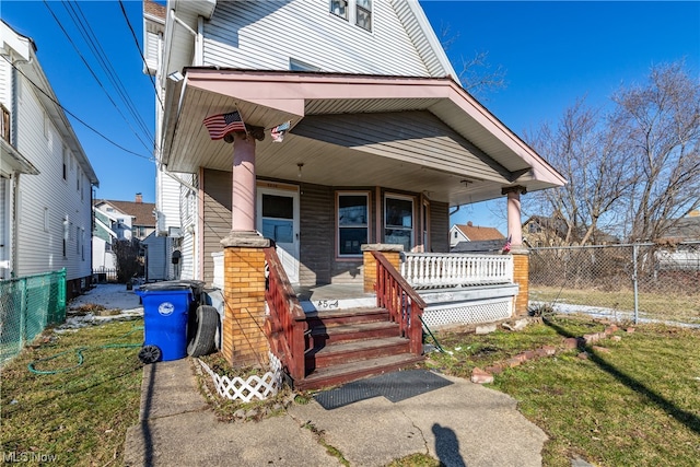 view of front of home with a porch and a front lawn