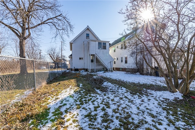 view of snow covered rear of property