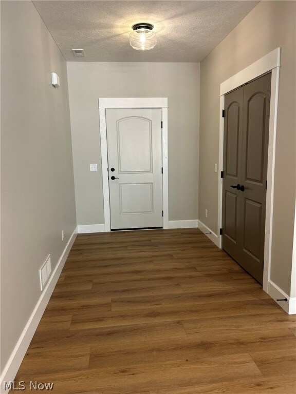 944 Queen Anne Dr NW, Massillon, OH 44647 - entryway featuring wood-type flooring and a textured ceiling