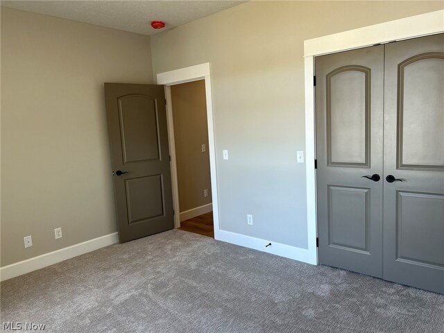 944 Queen Anne Dr NW, Massillon, OH 44647 - unfurnished bedroom featuring carpet flooring and a closet