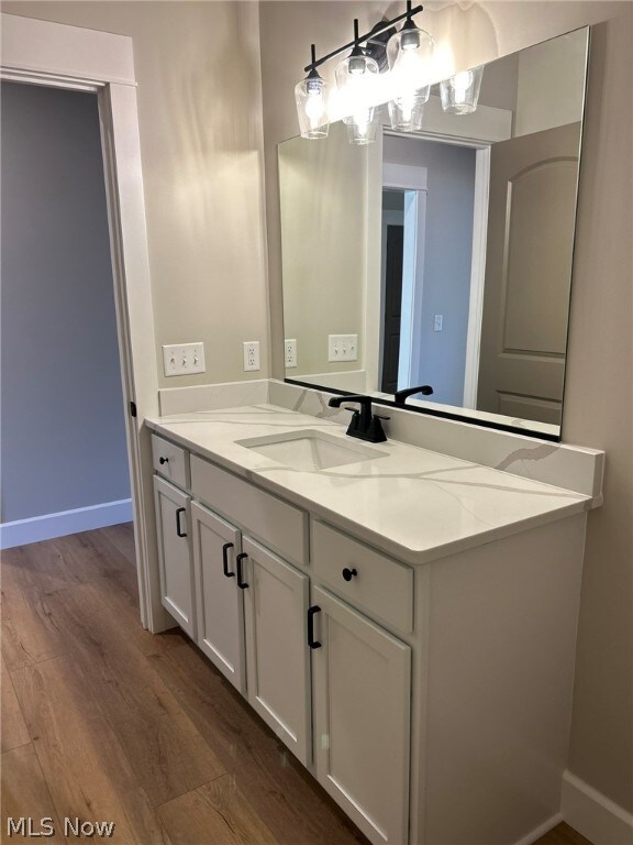 944 Queen Anne Dr NW, Massillon, OH 44647 - bathroom featuring vanity and hardwood / wood-style flooring