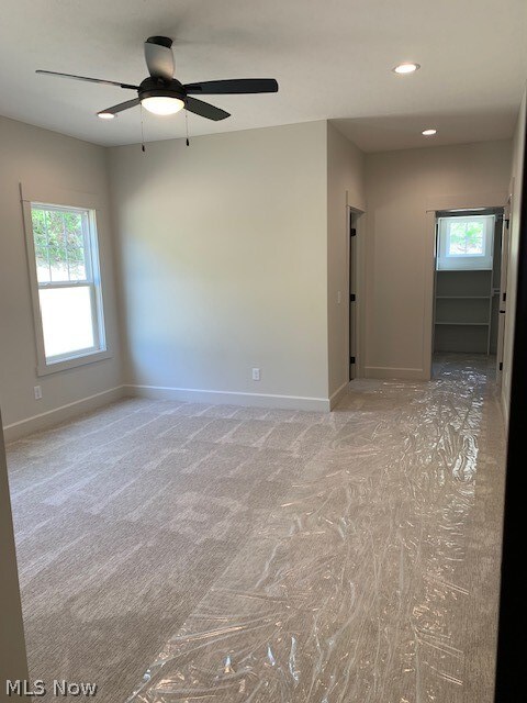 empty room with carpet and ceiling fan