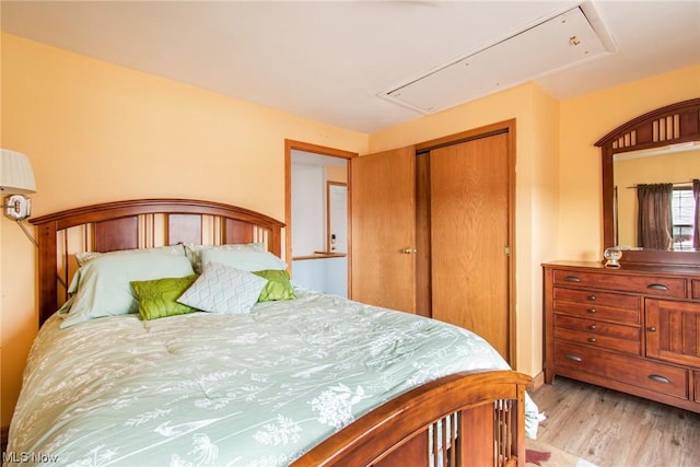 bedroom featuring a closet and light wood-type flooring