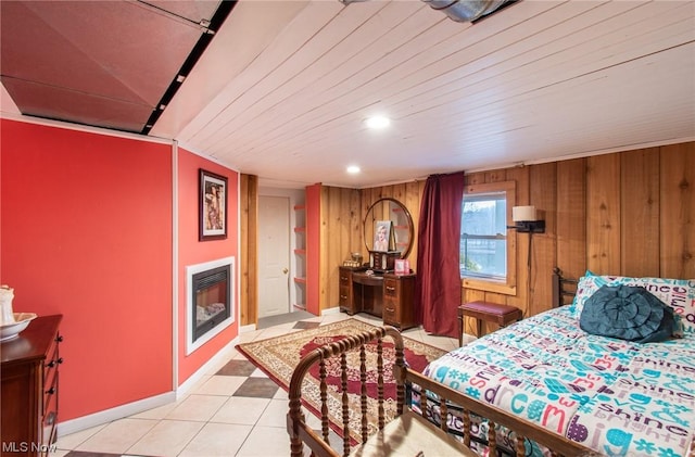 bedroom featuring wood walls, light tile patterned floors, and wooden ceiling