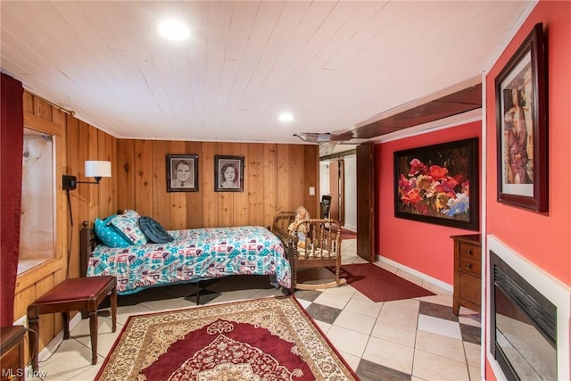 bedroom with light tile patterned floors and wood walls