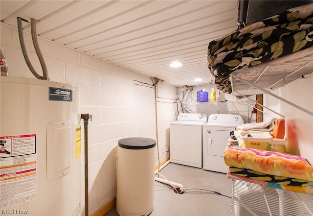 laundry area featuring washing machine and clothes dryer and water heater