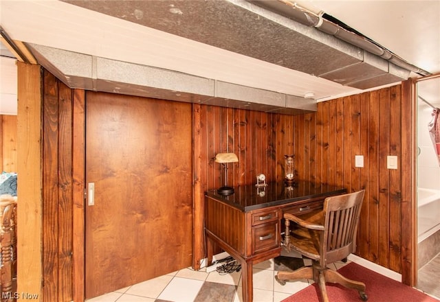 office with light tile patterned floors and wooden walls