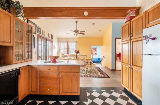 kitchen with kitchen peninsula, ceiling fan, lofted ceiling with beams, white refrigerator, and dishwasher