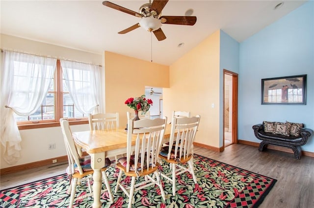 dining area featuring wood-type flooring, vaulted ceiling, and ceiling fan