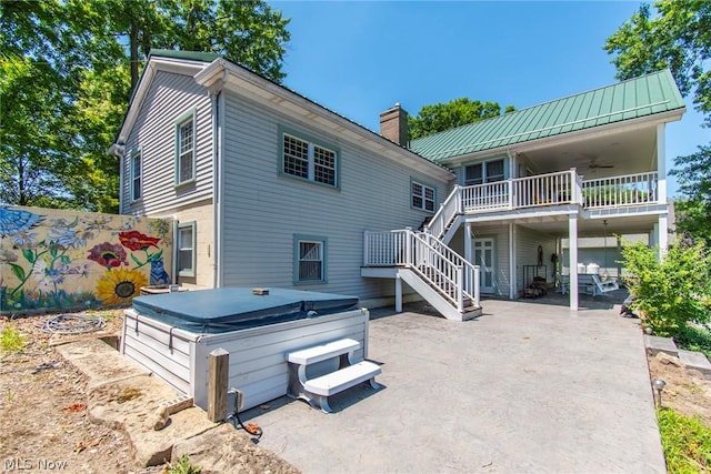 back of property with a patio, a hot tub, and ceiling fan