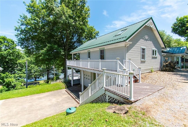 back of property with a yard and a garage