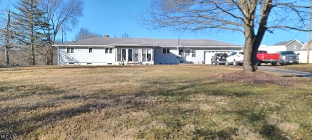 single story home with a front yard and a garage