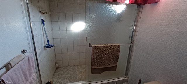 bathroom featuring a shower with door