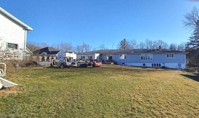 rear view of house featuring a yard