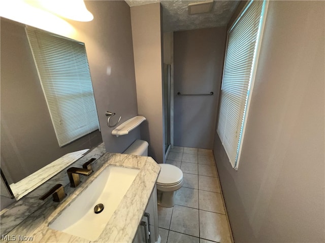 bathroom with toilet, tile floors, and vanity