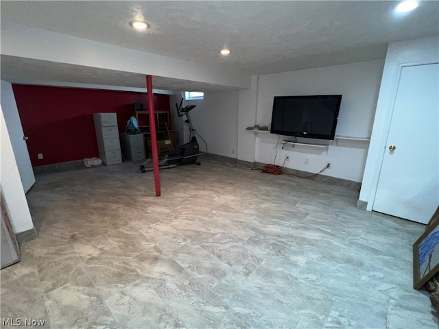 basement with tile flooring and a textured ceiling