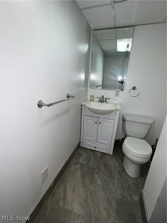 bathroom with tile flooring, vanity, and toilet