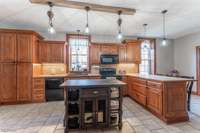 kitchen featuring black appliances, tasteful backsplash, a kitchen island, pendant lighting, and sink