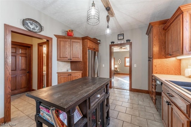 kitchen with dishwasher, light tile patterned floors, stainless steel fridge, and hanging light fixtures