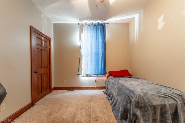 bedroom featuring light carpet