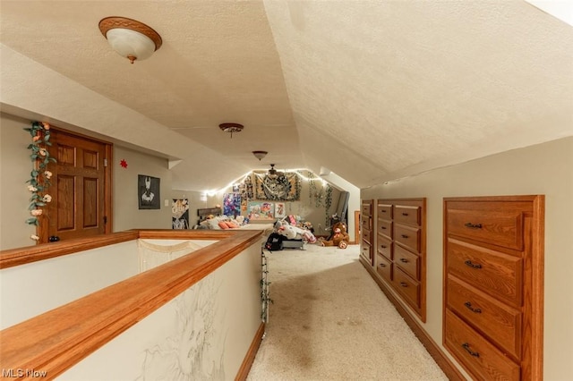 bonus room featuring a textured ceiling, light carpet, and lofted ceiling