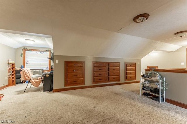 bonus room featuring light colored carpet, a textured ceiling, and vaulted ceiling