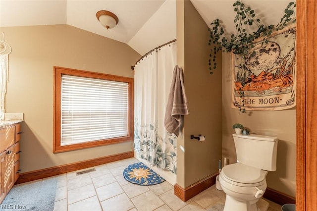 bathroom with lofted ceiling, tile patterned floors, vanity, toilet, and a shower with shower curtain