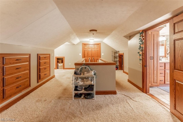 bonus room with lofted ceiling and light colored carpet