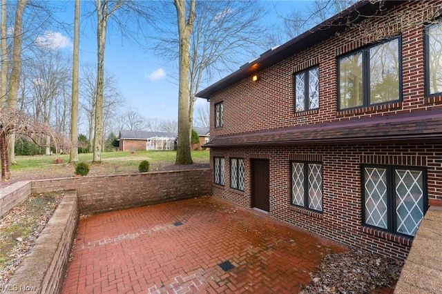 view of side of home featuring a patio area