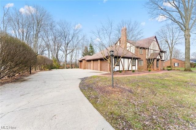 view of side of property featuring a yard and a garage