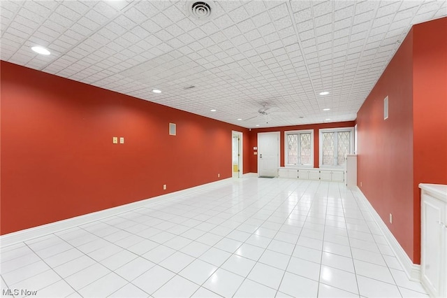 tiled empty room with ceiling fan