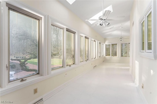 hall with tile patterned floors and a skylight