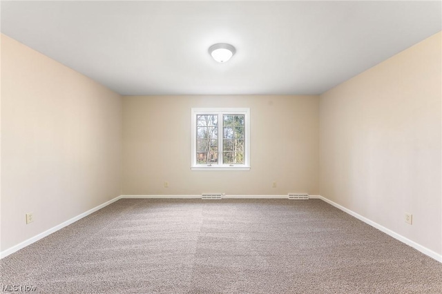 unfurnished room featuring carpet