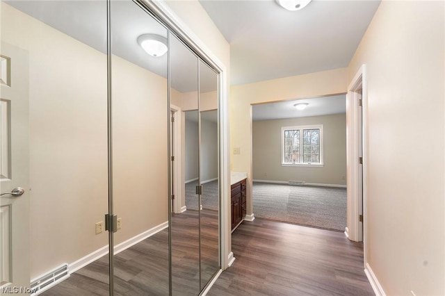 corridor with dark hardwood / wood-style flooring