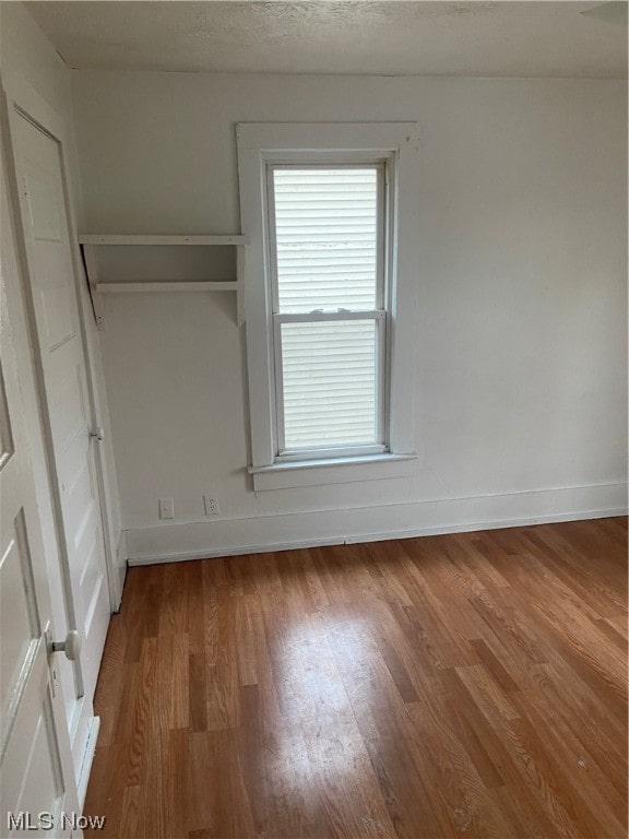 interior space with hardwood / wood-style floors and a textured ceiling