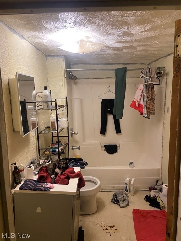 full bathroom featuring  shower combination, concrete flooring, vanity, a textured ceiling, and toilet