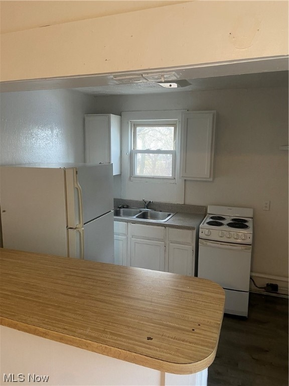 kitchen with white cabinets, white appliances, dark wood-type flooring, and sink