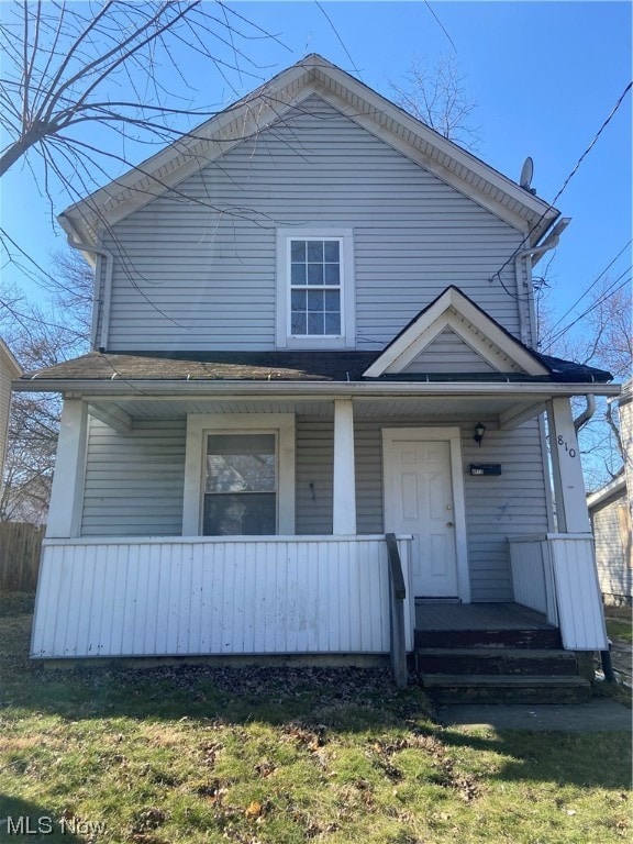 view of front of house with a porch and a front yard