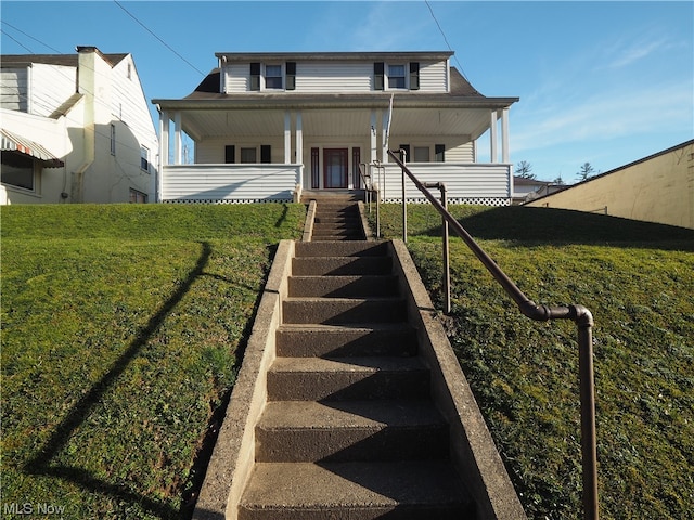 view of front of house with a front yard and a porch