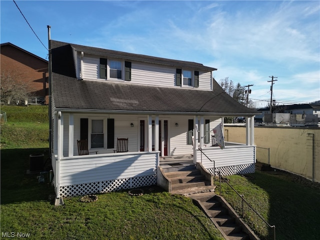 view of front facade with covered porch and a front lawn